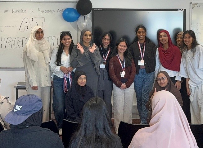 Photo showing DDaT Director, Atika, with the group that attended the hackathon.